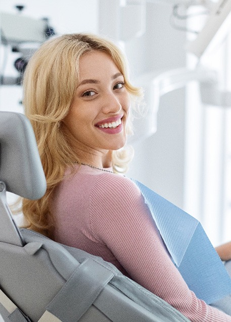 Patient smiling while sitting in treatment chair