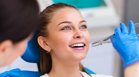 Woman smiling about to have tooth extracted