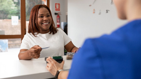 Woman paying for dental work