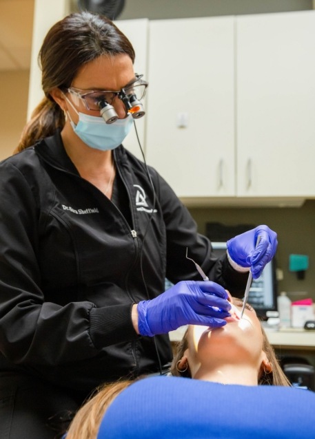 Smiling woman in dental chair before dental exam and cleaning in Tampa