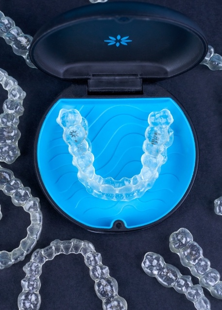 Several Invisalign clear aligners in Tampa on desk