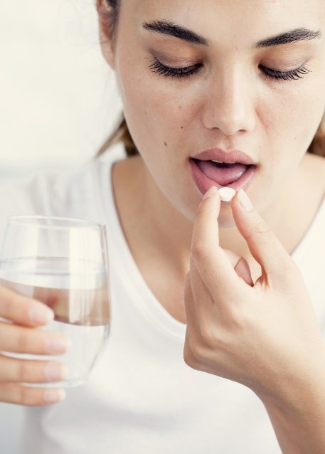 Woman taking a pill for oral conscious sedation dentistry in Tampa