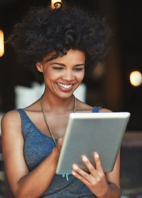 Smiling woman scrolling on a tablet