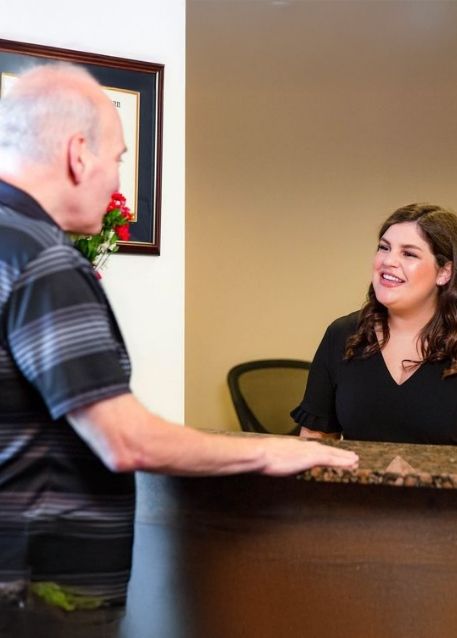 Patient handing a payment card to their dentist