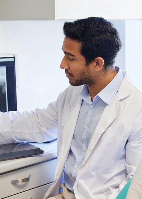 a dentist showing a patient her X-rays