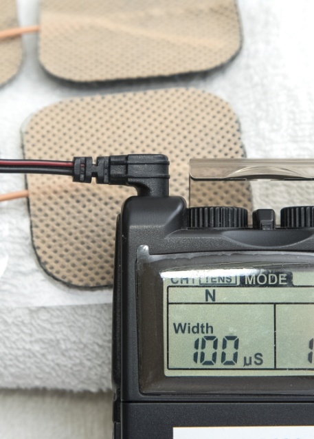 Wires plugged into small black box with screen