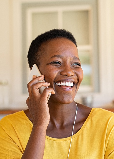 Woman smiling while talking on phone