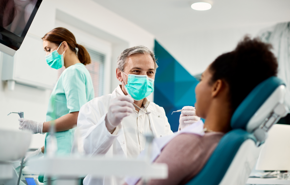 Dentist with patient in exam chair